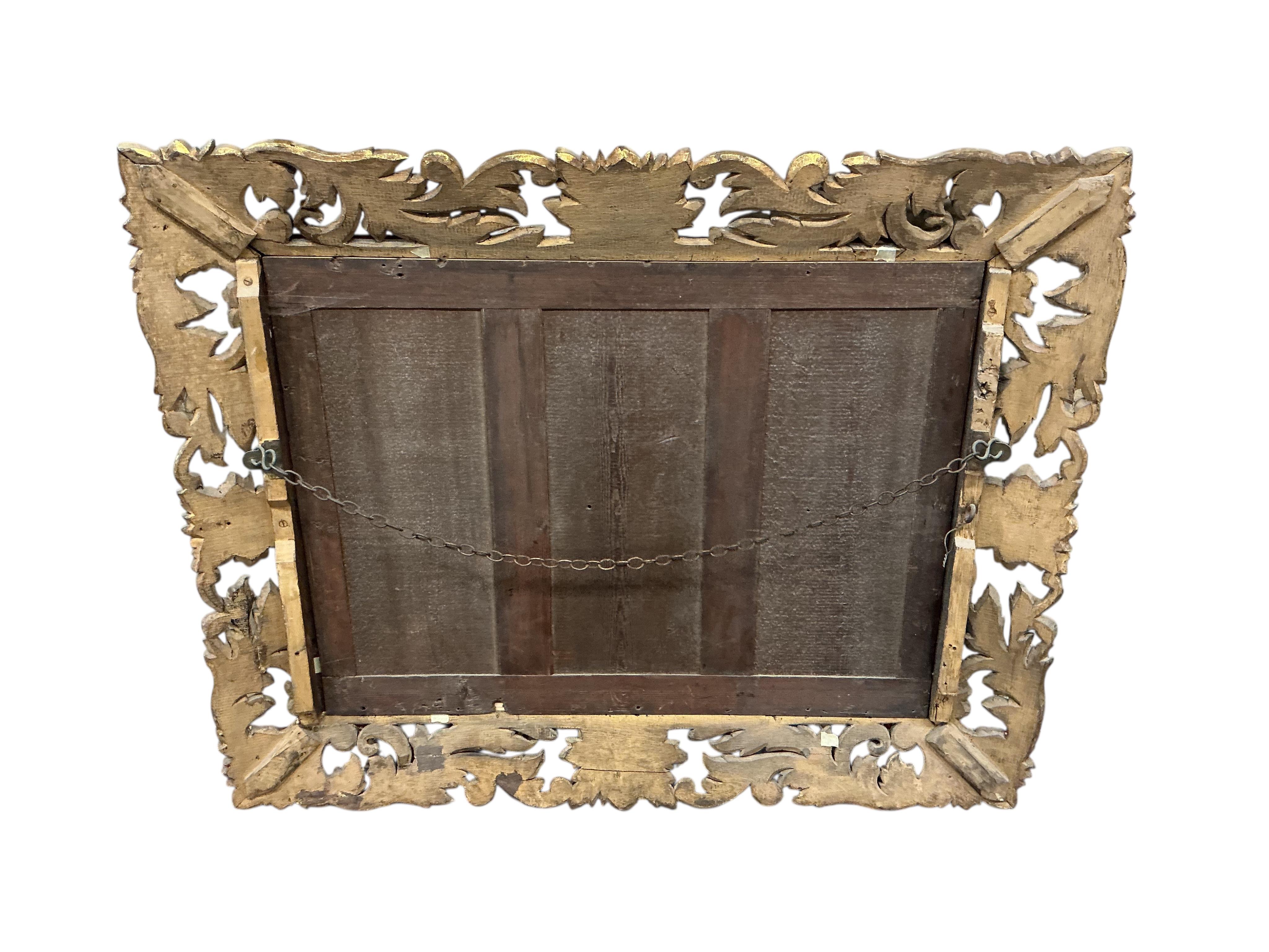 A rectangular carved giltwood Florentine style wall mirror with bevelled plate, width 110cm, height 90cm